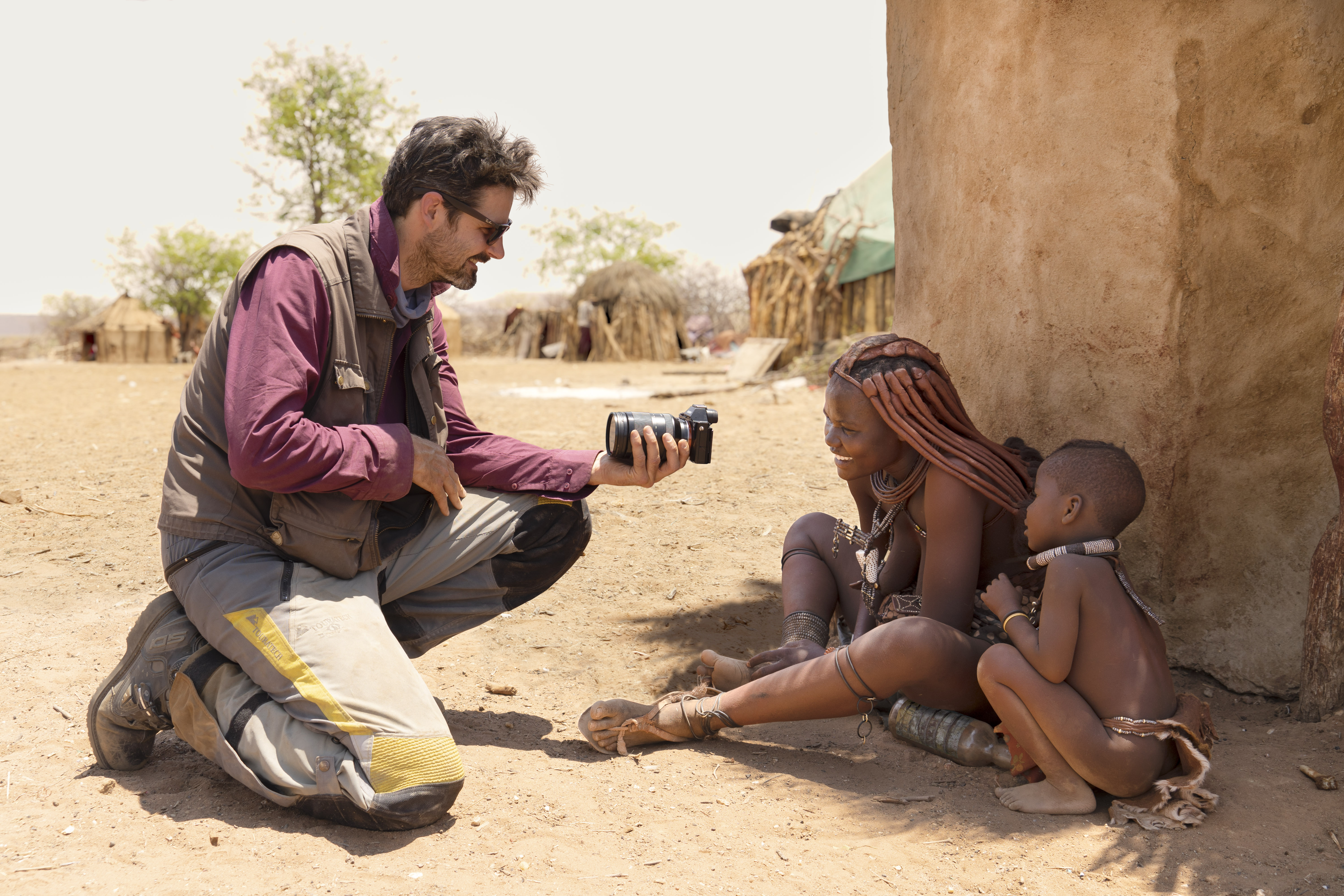 Daniel Rintz interacting with Himba tribal women in Namibia