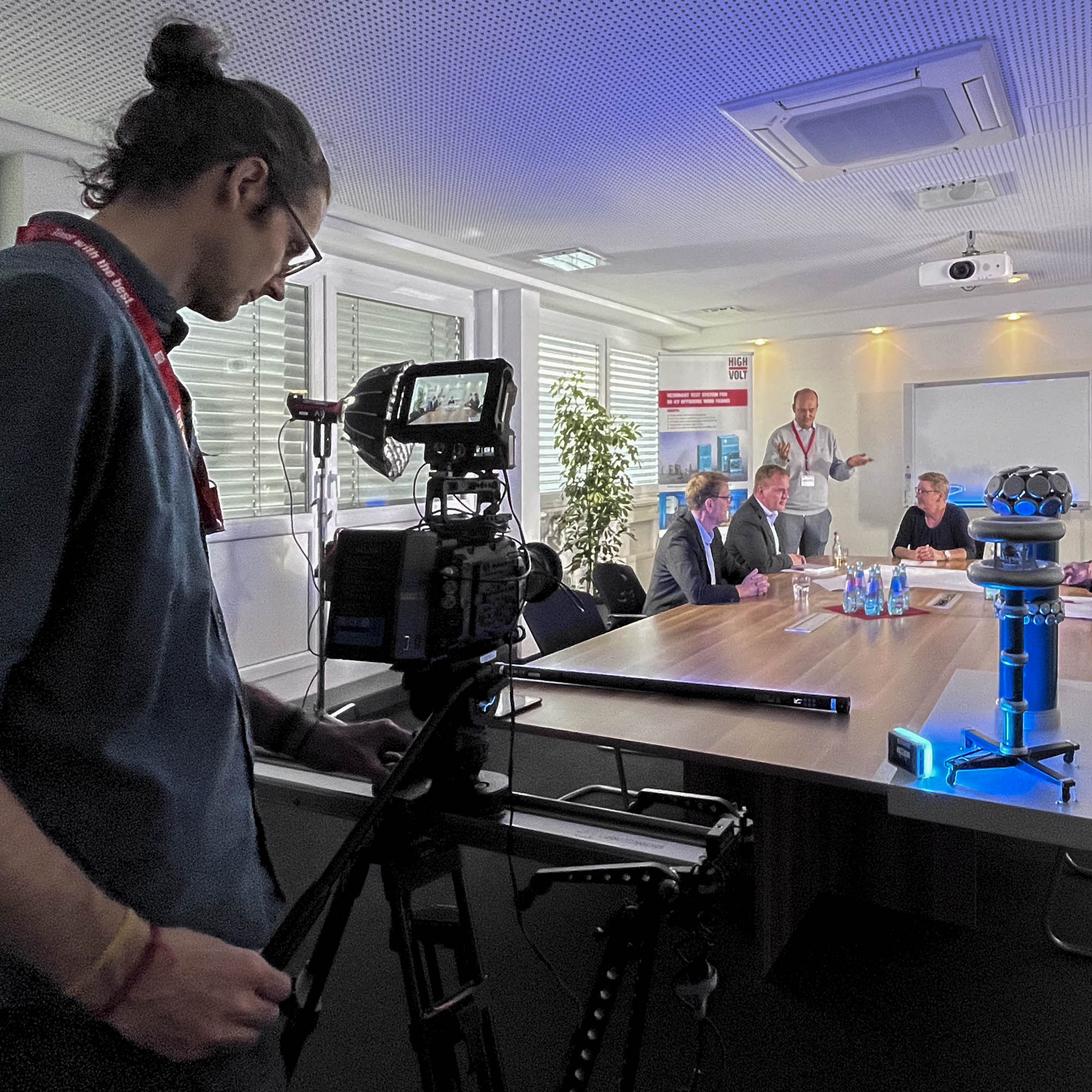 Daniel Rintz operating a camera during a commercial film shoot inside a company building